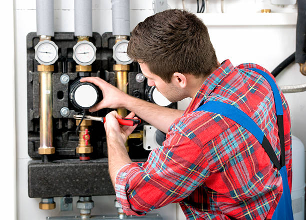 Technician servicing the gas boiler for hot water and heating